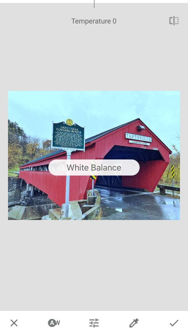 A screenshot of a covered bridge demonstrating how to use white balance in Snapseed