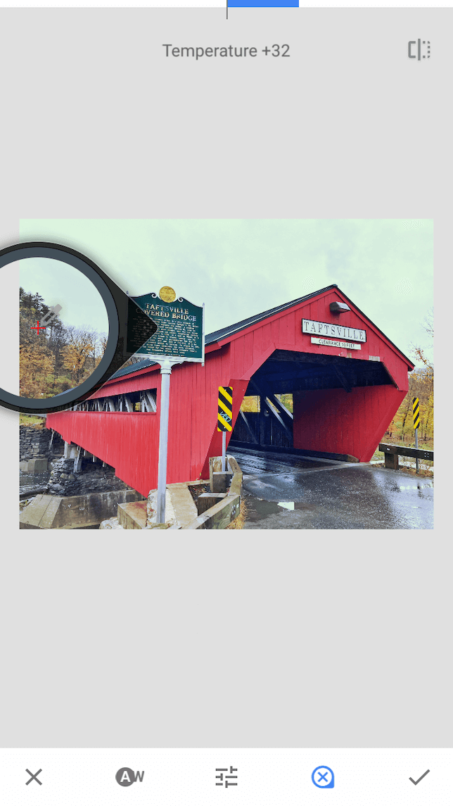 A screenshot of a covered bridge demonstrating how to use white balance in Snapseed