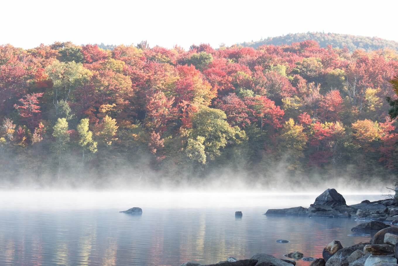 an image featuring a lake with fog rising from it. Captured using burst mode on iPhone