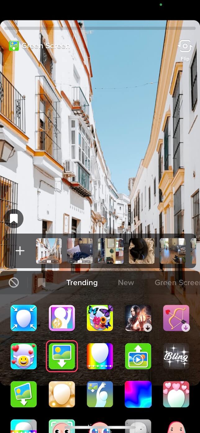 Screenshot showing how to use the green screen effect on TikTok with a photo background.
