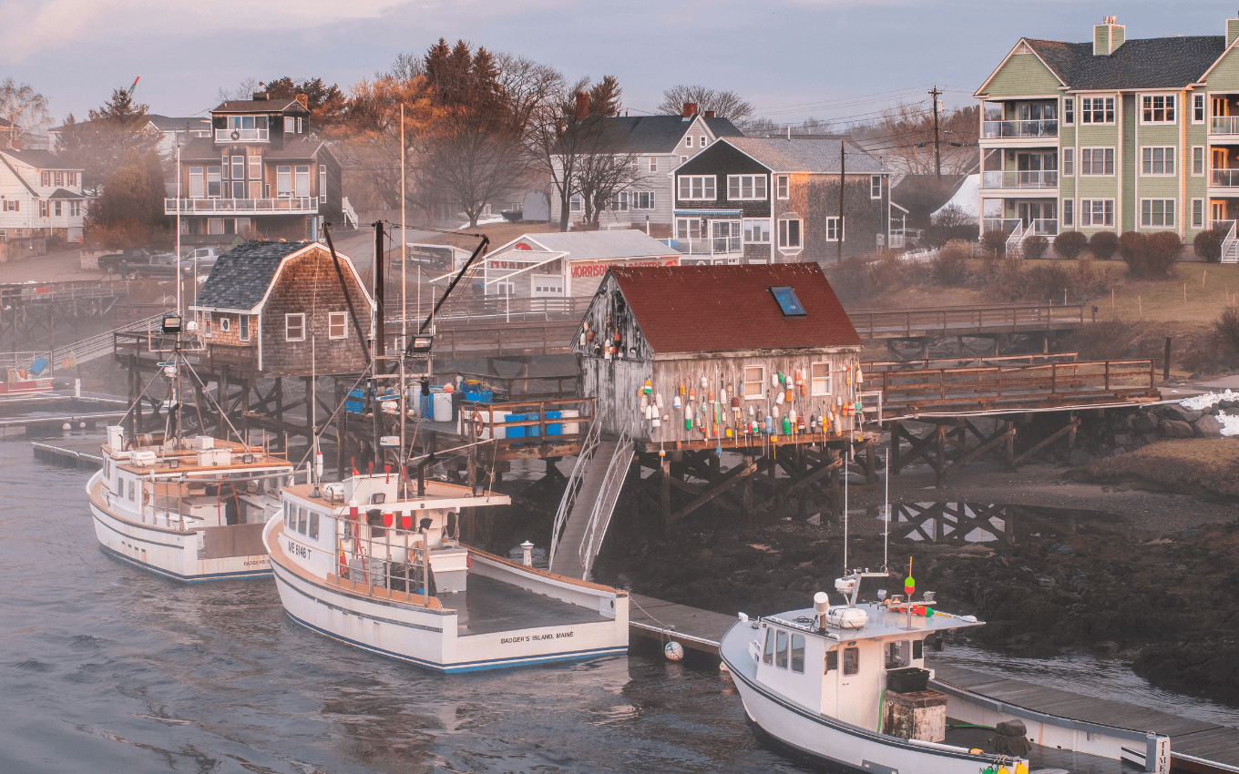 Several lobster boats moored next to a pier in New England, demonstrating the golden triangle in photography.