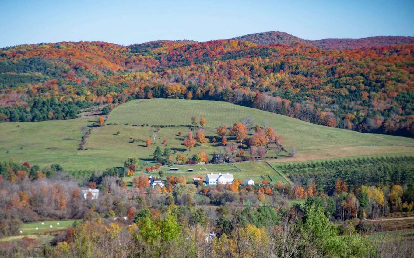 A pastoral view during the fall in Vermont, showing a strong but not straight horizon line.
