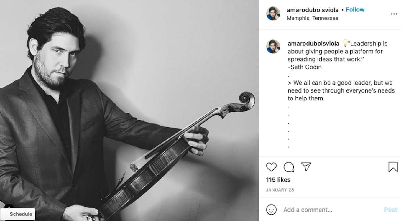 A black-and-white photo of a man holding a violin, which shows good use of negative space.