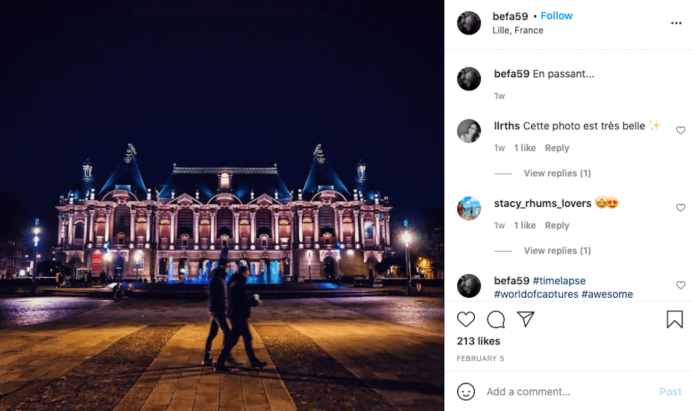 An Instagram screenshot of a couple walking through a city at night.