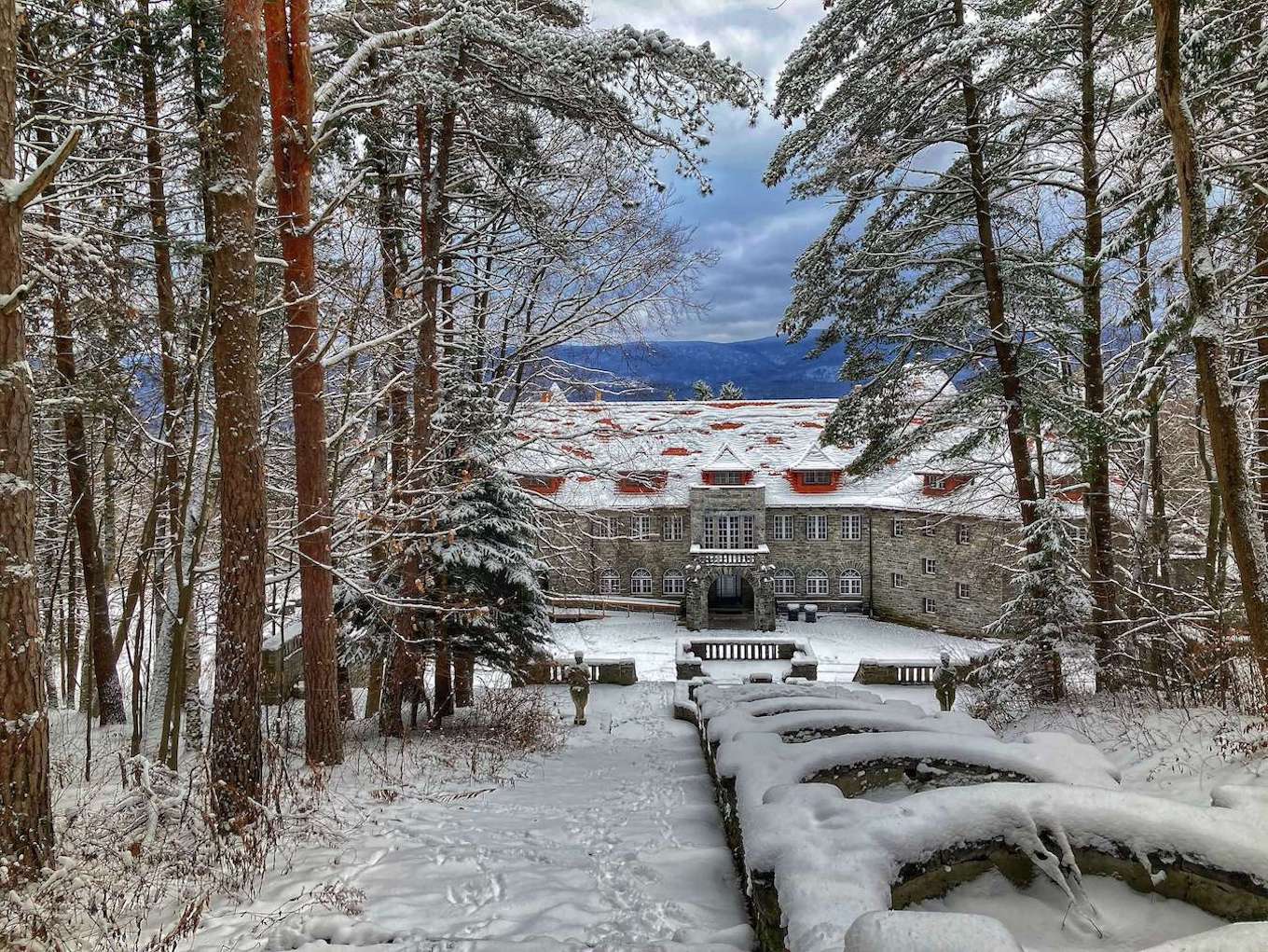 Leading lines in photography show a snow-covered fountain leading to a castle.