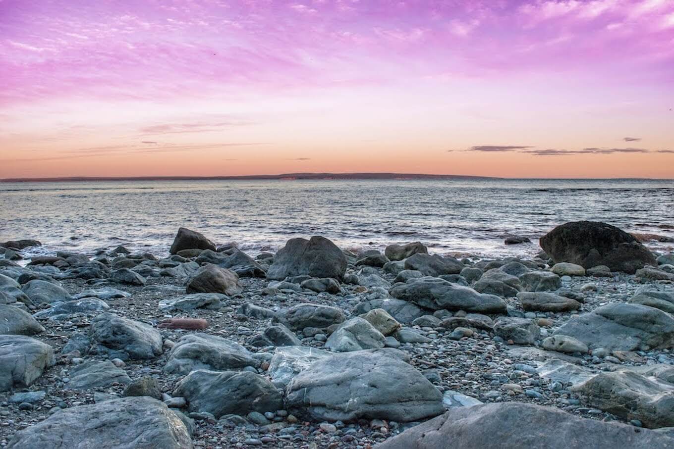 A photo of a rocky beach at sunset to demonstrate what nature photography is.