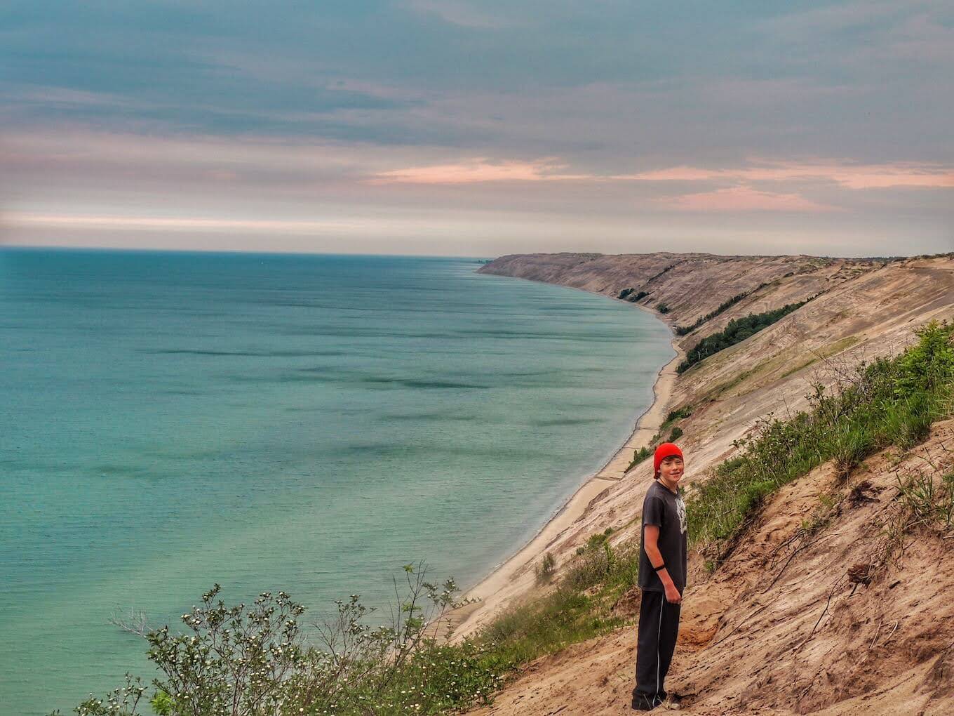 A person standing in front of a beach landscape to demonstrate scale in nature photography.