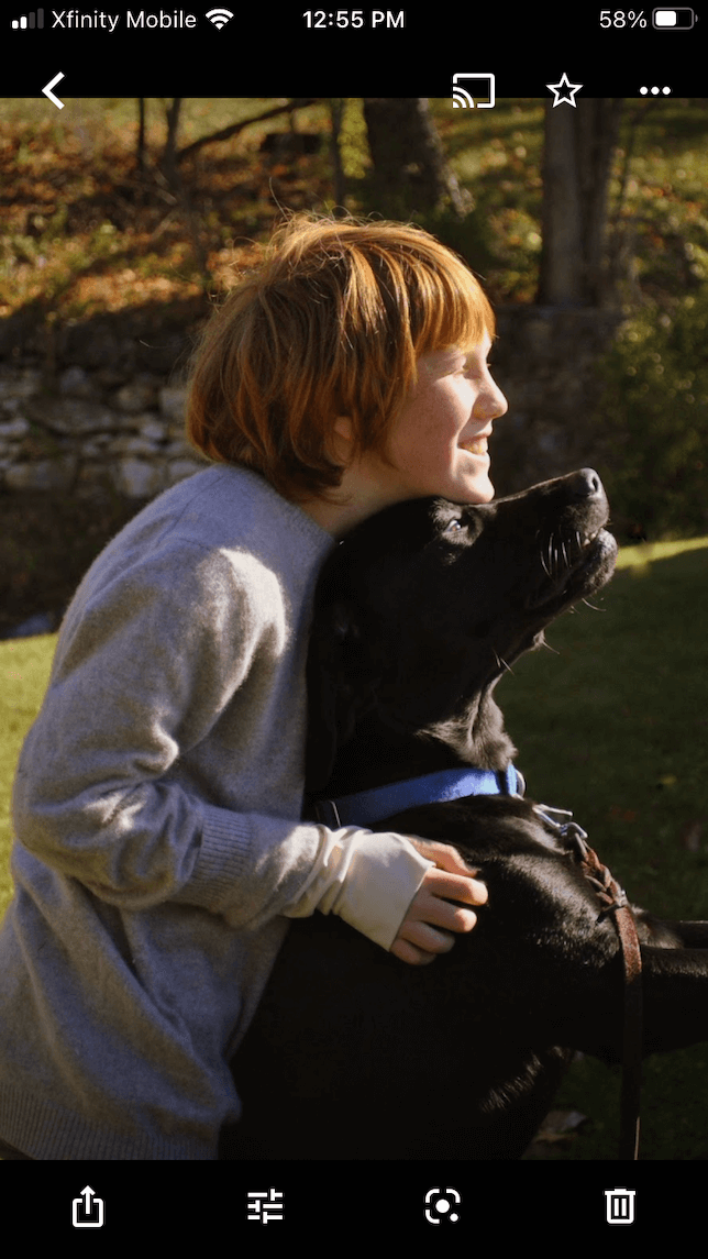 A photo of a boy and a dog before editing in Google Photos.