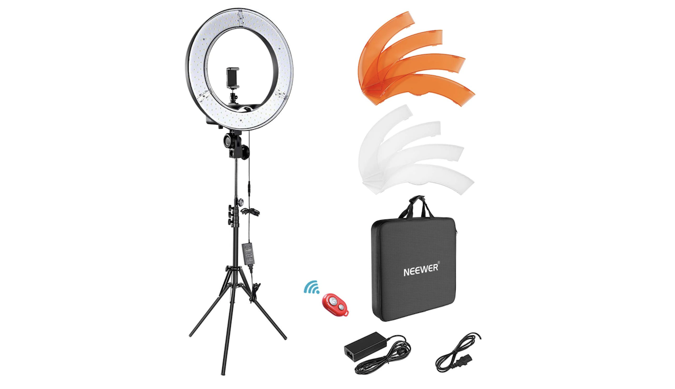 A selfie ring light mounted on a tripod with additional accessories.